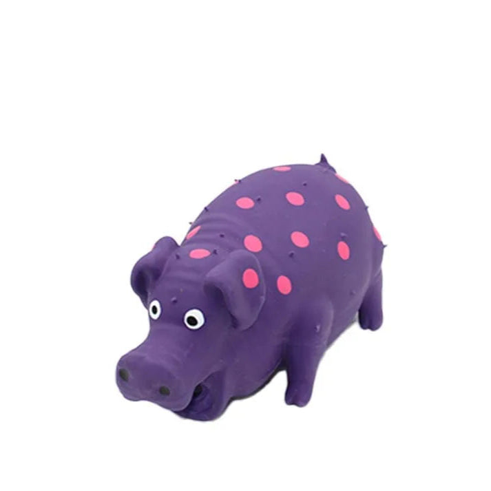 Purple pig-shaped squeaky dog toy with pink spots, made of soft latex for playful chewing and pet fun